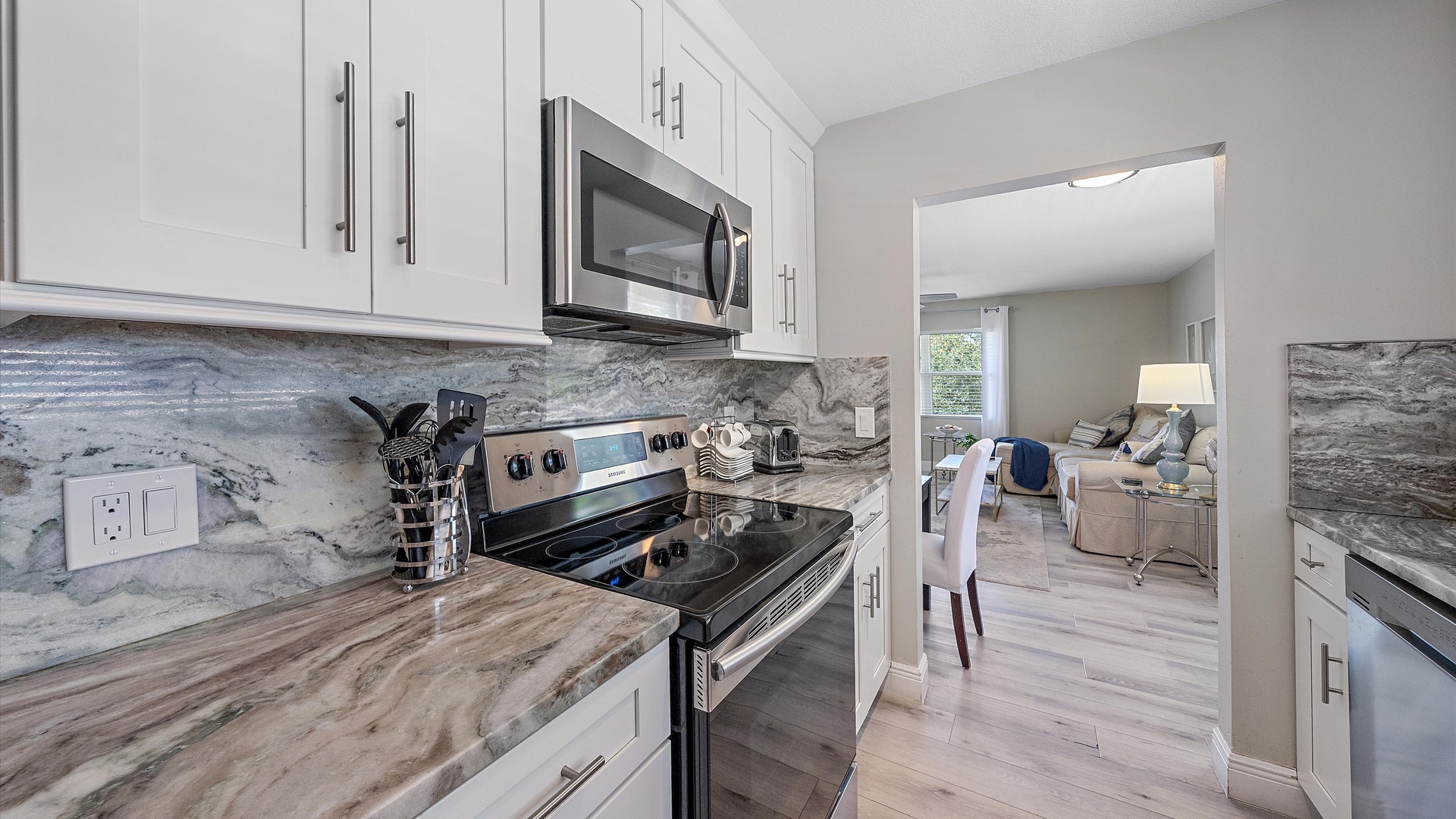 Your fully equipped kitchen features sleek marble countertops, modern appliances, and stylish cabinetry—everything you need to prepare your favorite meals in comfort.