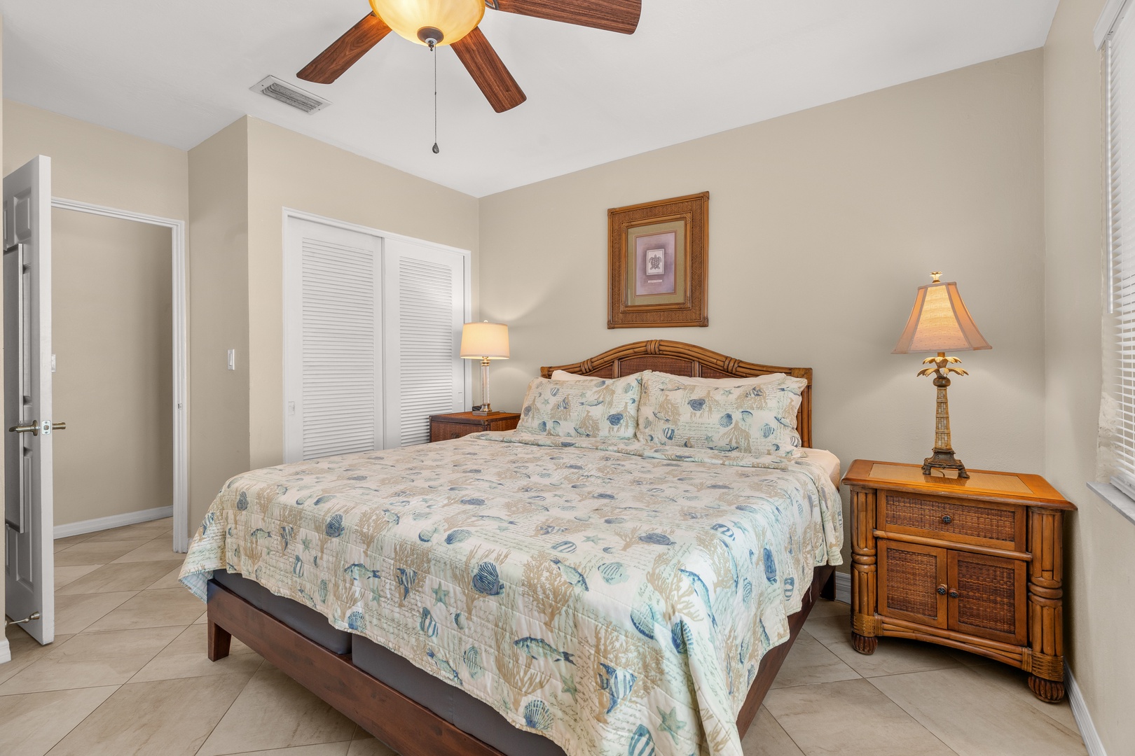 Drift off to sleep in your coastal-themed bedroom, complete with ceiling fan and charming seashell bedding that whispers of ocean dreams.