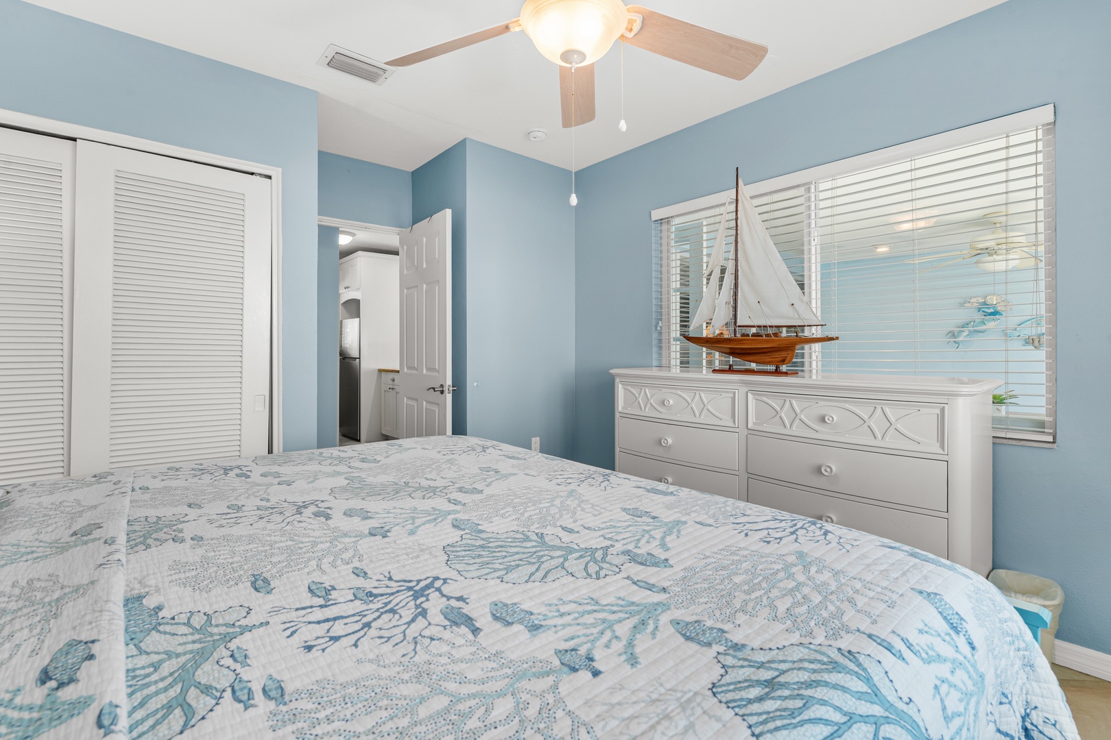 Rest peacefully in your coastal-themed bedroom, where nautical blues and gentle ceiling fan breezes create your perfect seaside retreat.