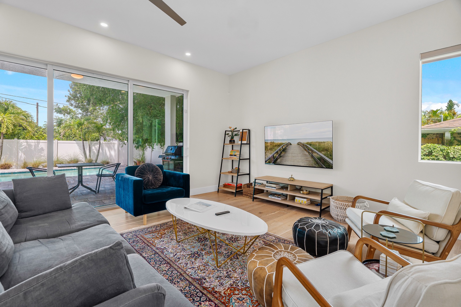 Sink into plush sofas and let the sunshine stream through expansive windows. Your private pool beckons just beyond the glass doors, ready for lazy afternoons.