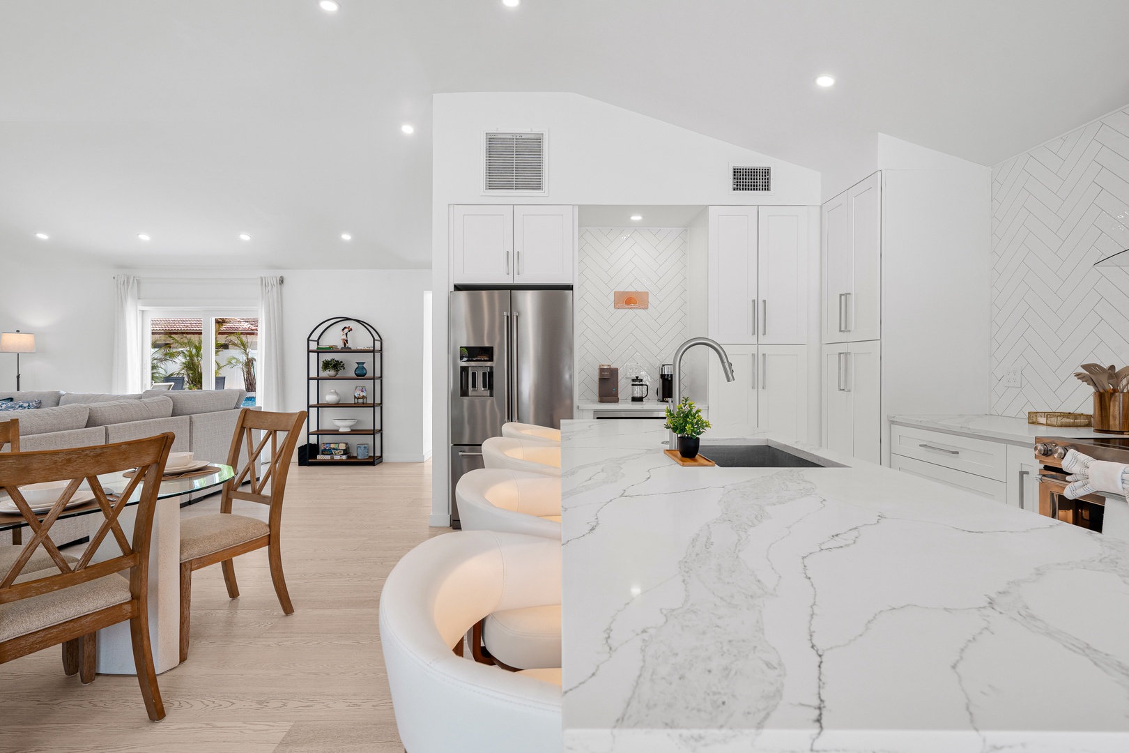 Picture yourself preparing meals in this bright, open-concept kitchen with its stunning marble island, modern appliances, and spacious layout flowing seamlessly into the dining and living areas—perfect for gathering with family and friends.