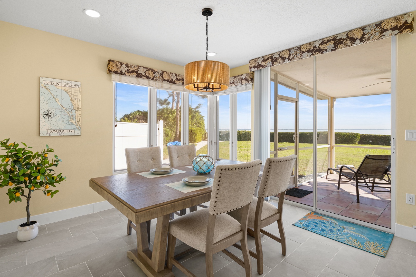 Your bright dining space opens to a serene patio where you can enjoy meals with sweeping views of the lush landscape beyond.
