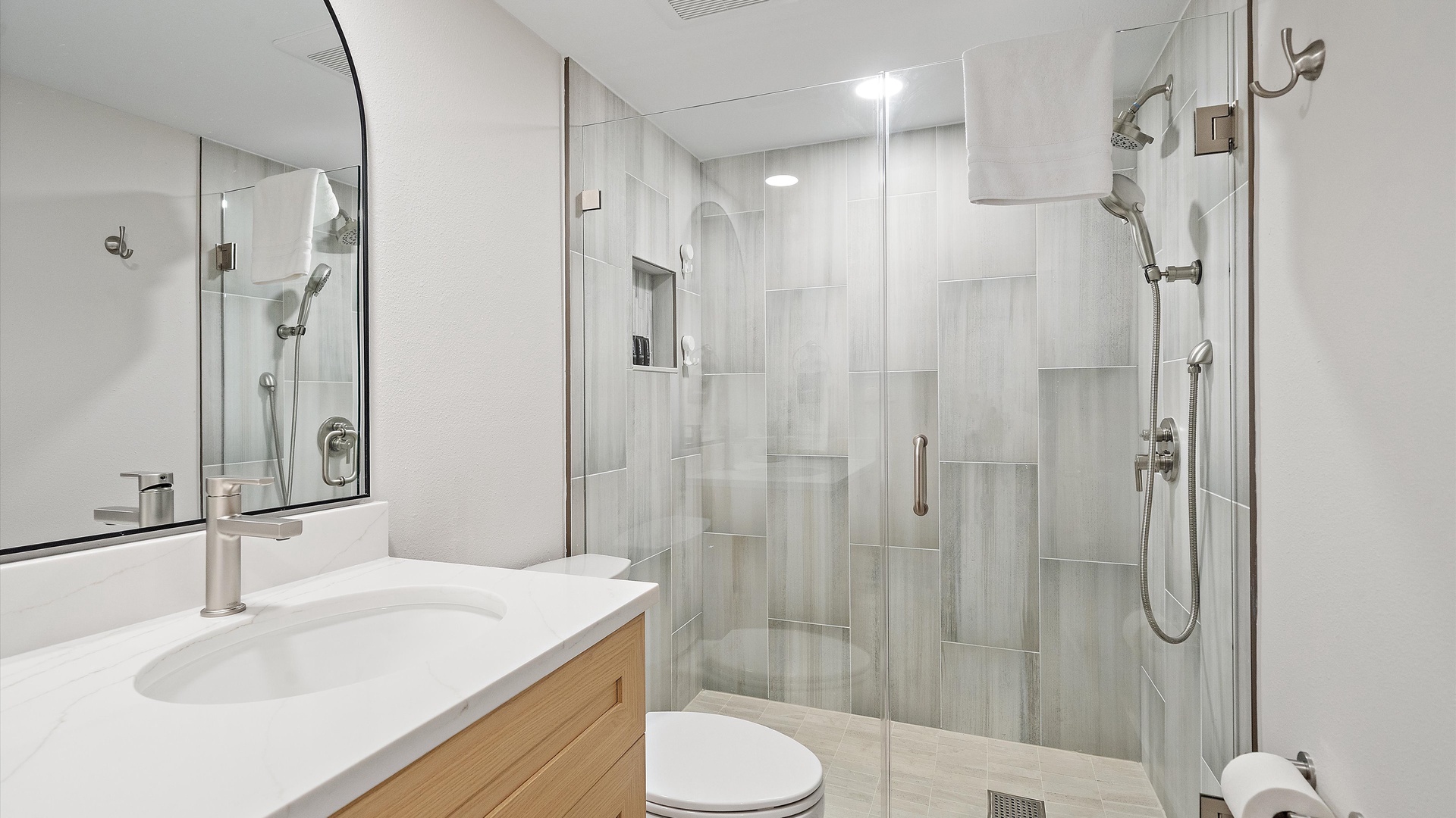 Step into your modern bathroom sanctuary with sleek glass shower and contemporary finishes for ultimate relaxation.