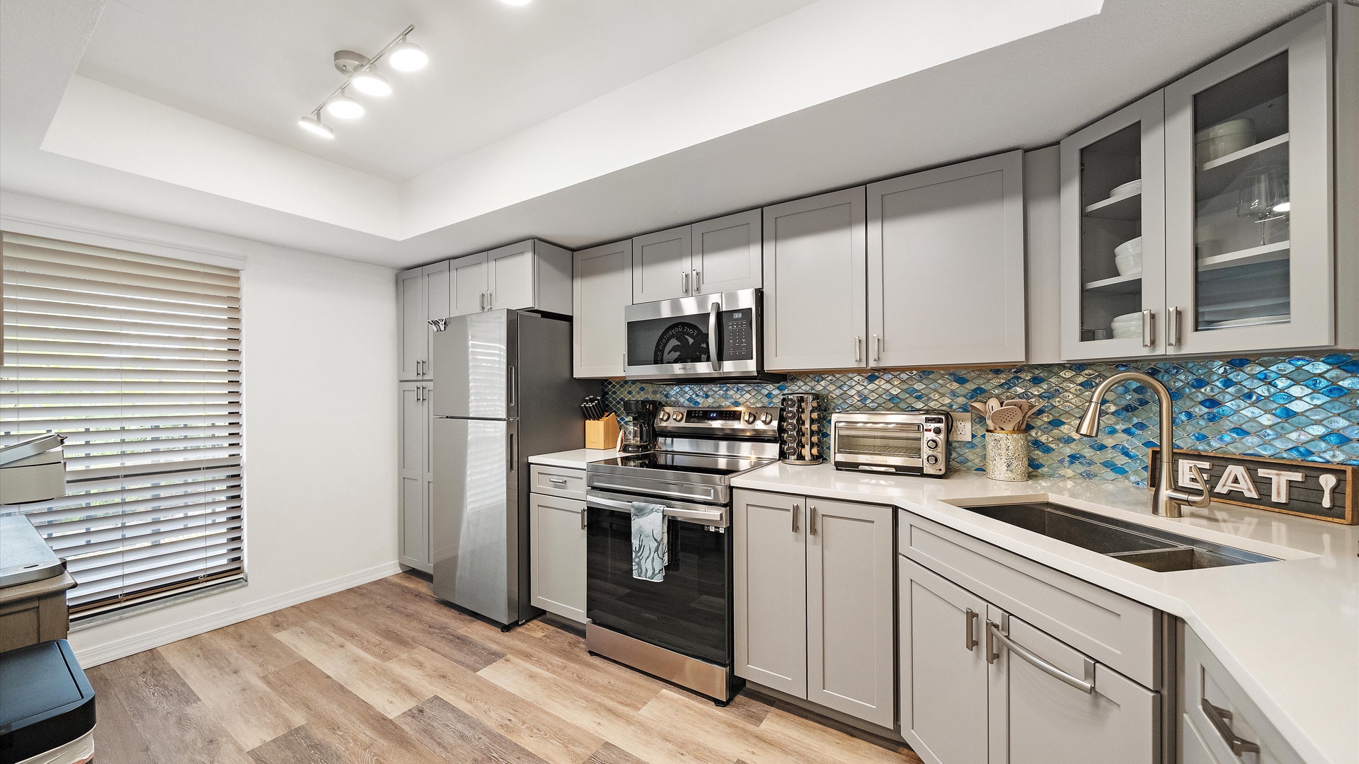 Your fully-equipped kitchen has everything you need to prepare delicious meals together—stainless steel appliances, spacious countertops, and stylish backsplash that adds a pop of color to the space.