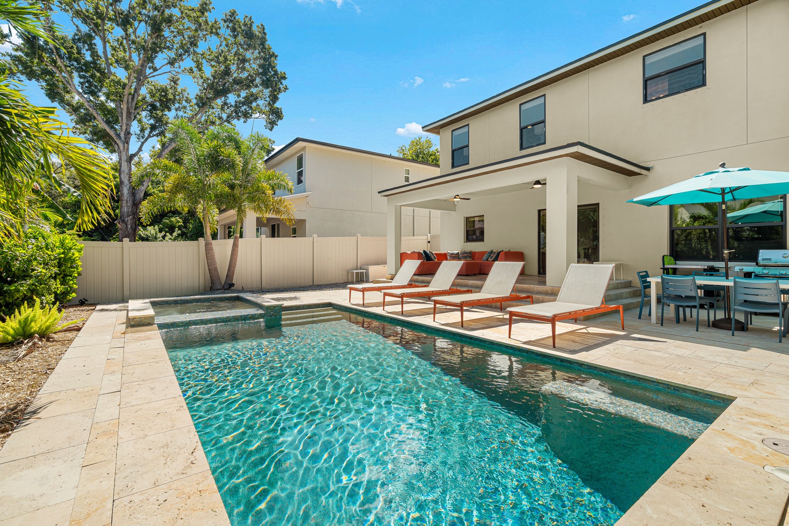 Your private oasis awaits—lounge poolside under swaying palms, soak up the sunshine, and unwind with outdoor dining steps from the sparkling water.