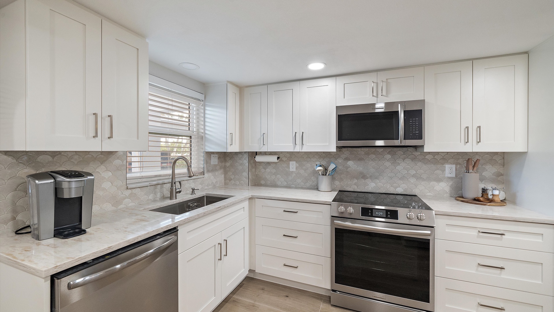 Your modern kitchen awaits with sleek white cabinets, granite counters, and stainless appliances for effortless meal prep.