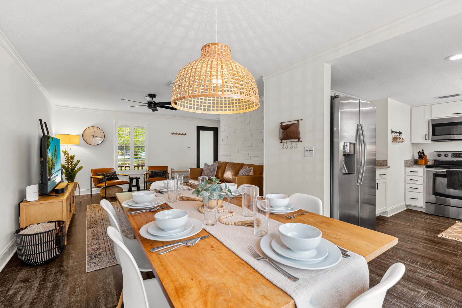 Gather around this warm dining table where meals become memories, then sink into the leather sofa as natural light fills your home away from home.
