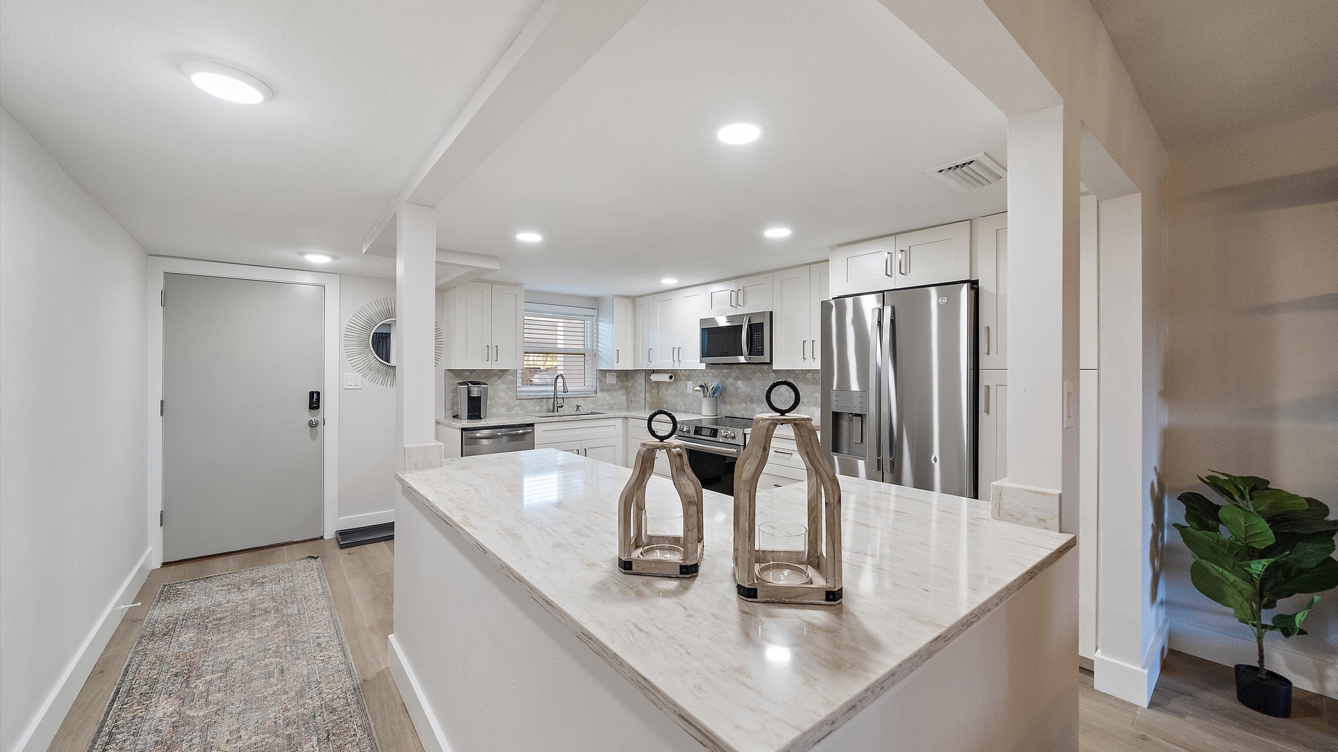 Your fully equipped modern kitchen features gleaming quartz counters, stainless steel appliances, and everything you need for memorable meals during your stay.
