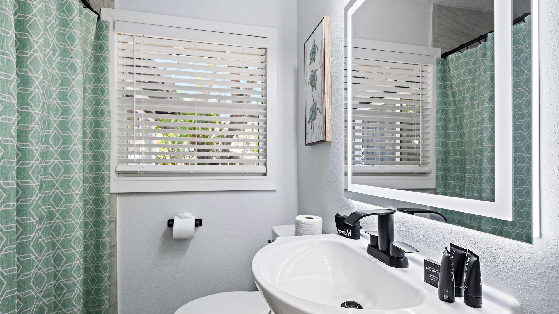 Refresh in your private bathroom with crisp green tilework, modern fixtures, and soft natural light filtering through the window blinds.