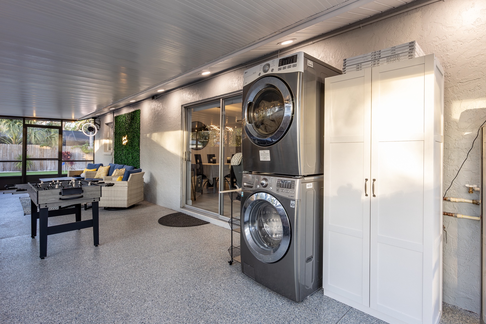 Your own private laundry setup with modern washer and dryer, plus entertainment space with foosball for fun between loads.