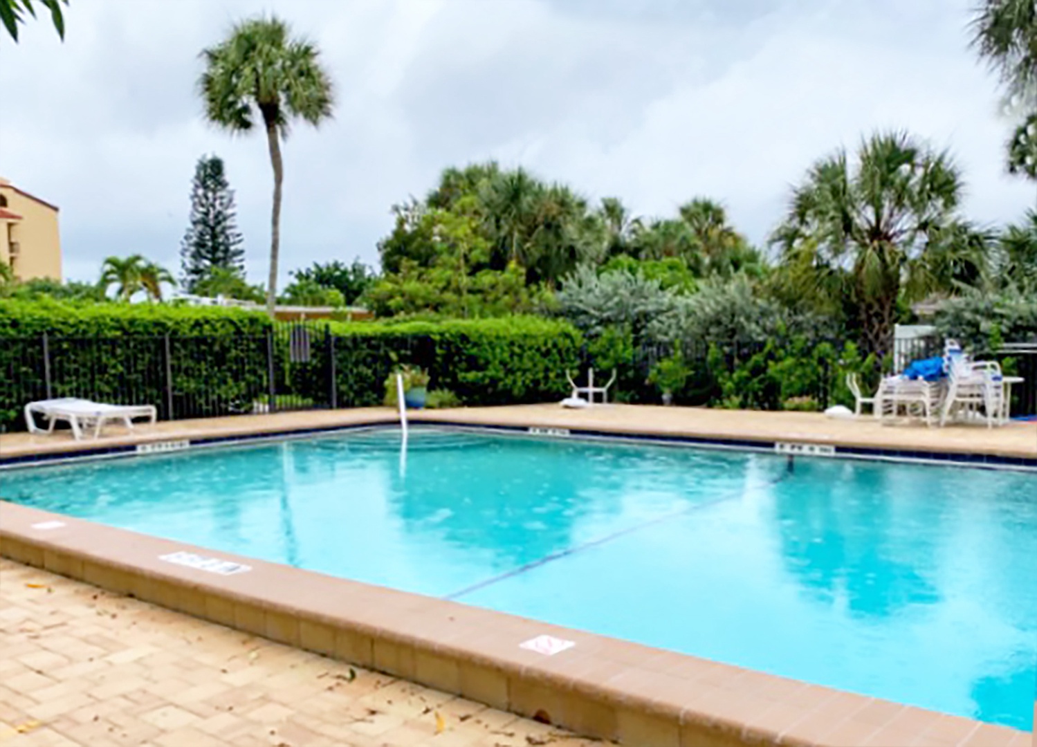 Lounge poolside after a day at the beach. Pool loungers and umbrellas available for guest use.