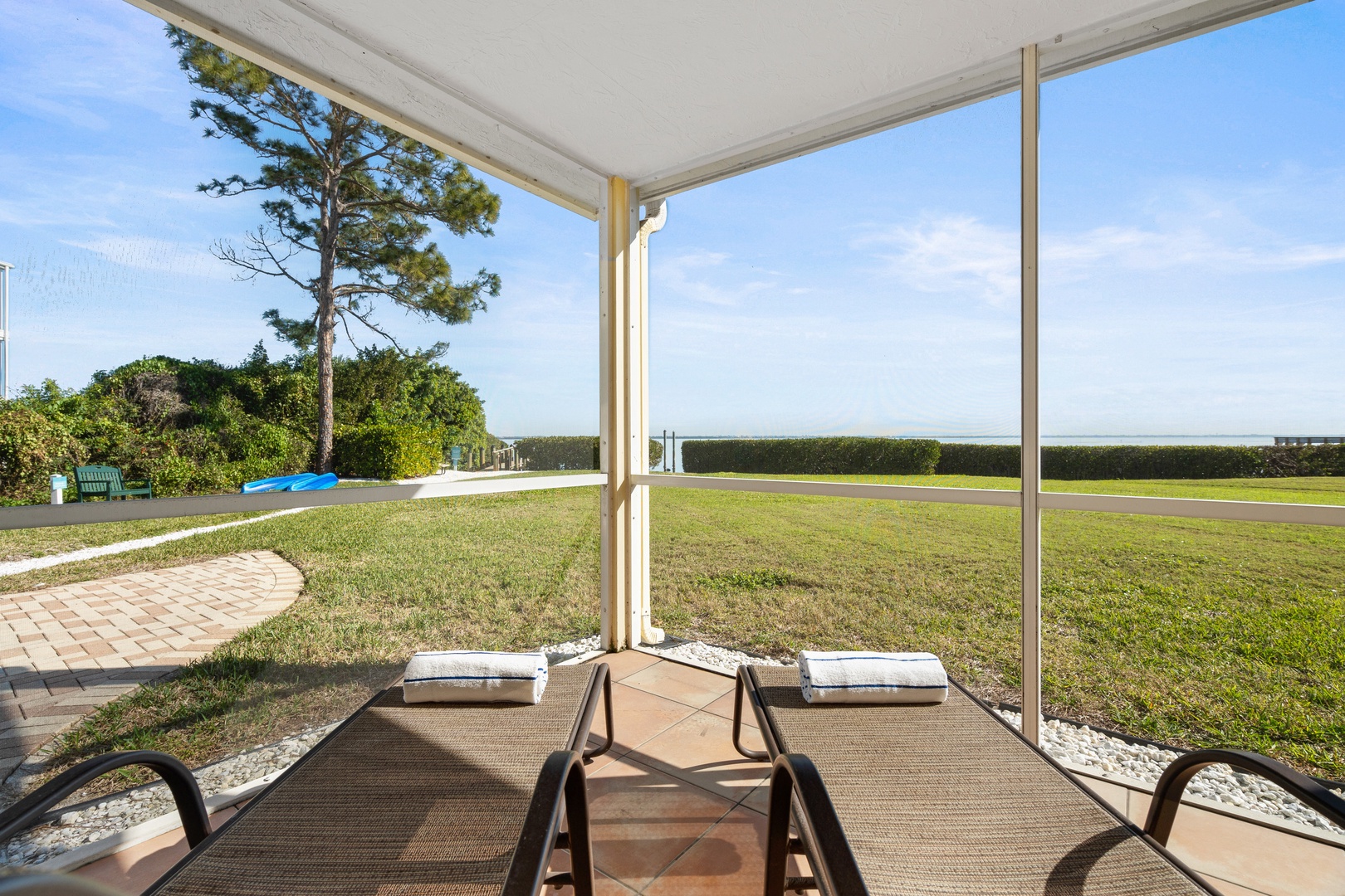 Relax in your private screened patio with comfortable loungers overlooking sprawling lawns and tranquil landscapes.