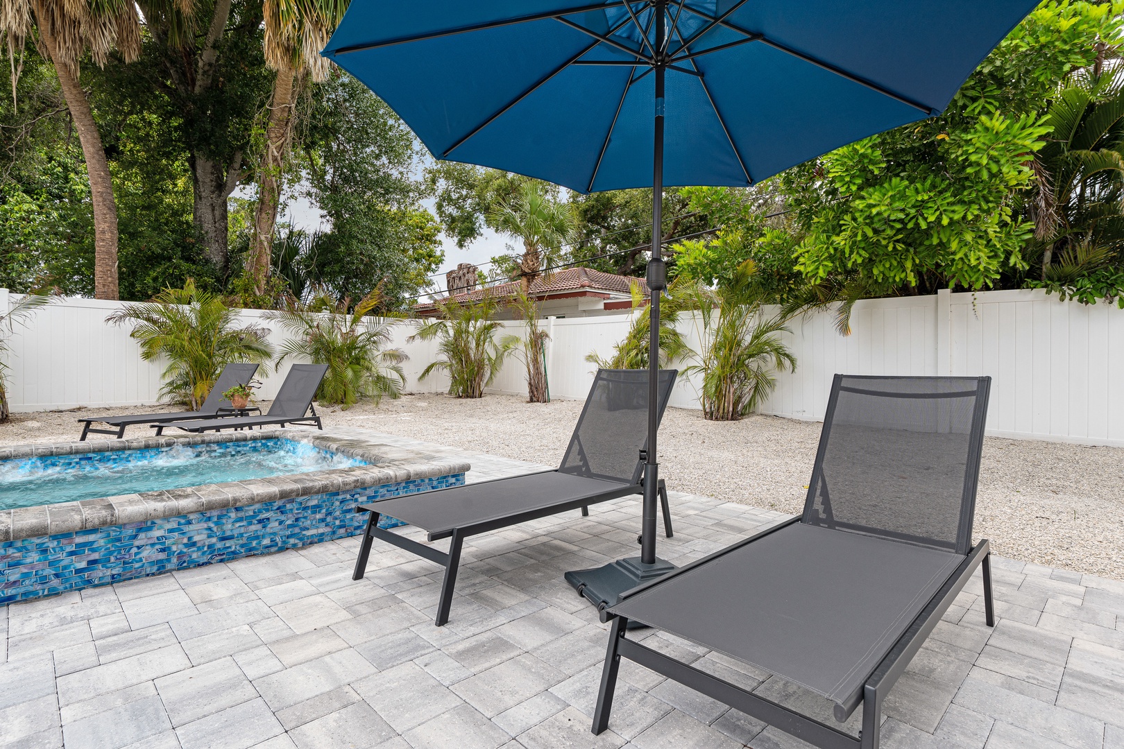 Lounge under the shade by your private pool, surrounded by tropical palms and serene privacy—your perfect escape awaits.