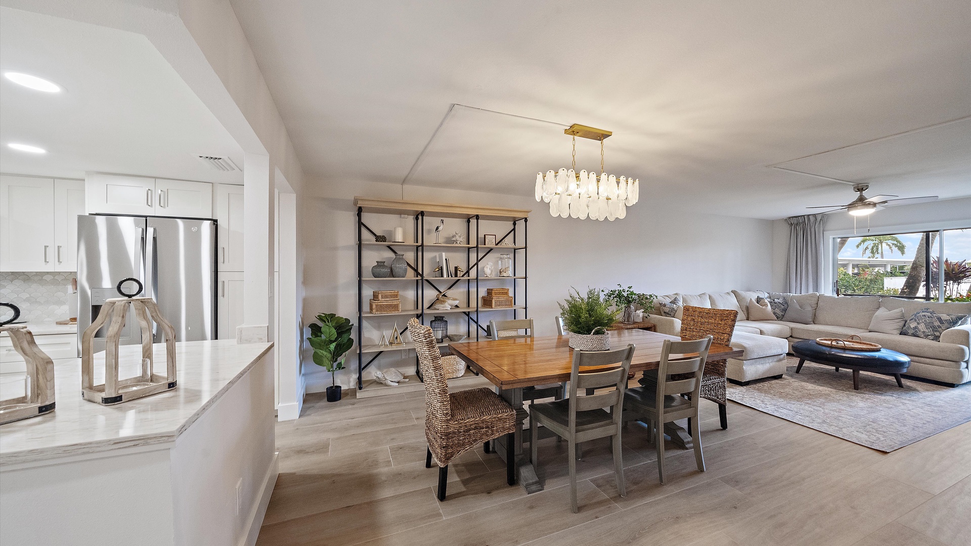 Your modern open-concept living space flows seamlessly from kitchen to dining to living room, with elegant lighting and natural views creating the perfect home base.