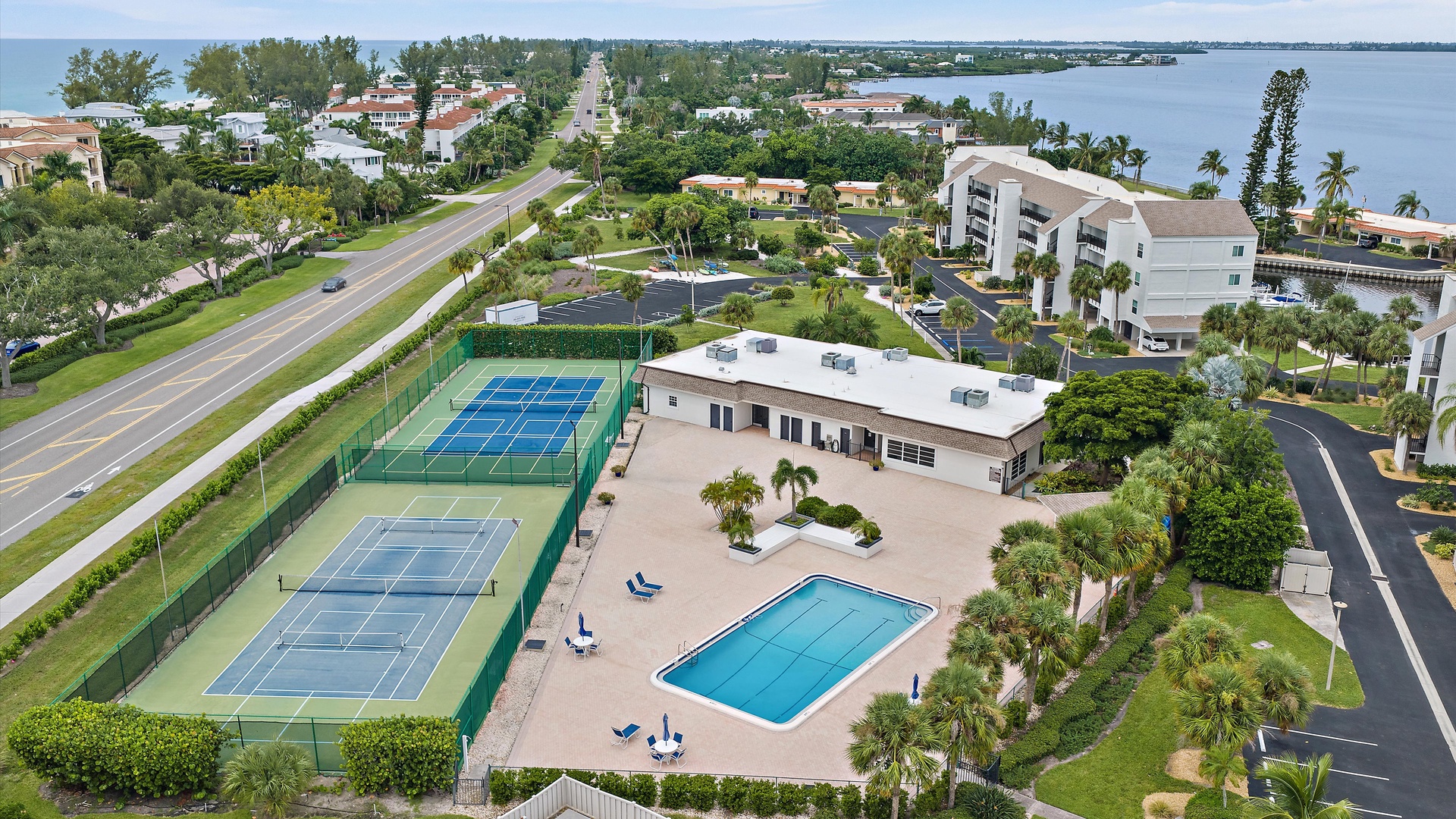 Pools, courts, and a beautiful bayfront setting—all part of life at Windward Bay. This aerial shows the community’s recreation areas and its location along Gulf of Mexico Drive on Longboat Key.