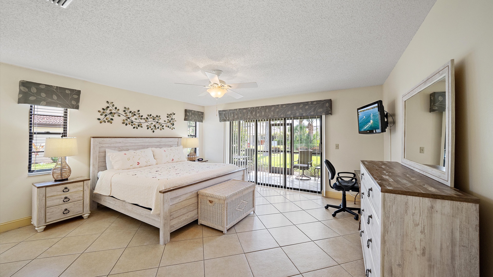 Wake up refreshed in this bright bedroom featuring a plush bed, convenient workspace, and sliding doors leading to your private outdoor space—perfect for your morning coffee.