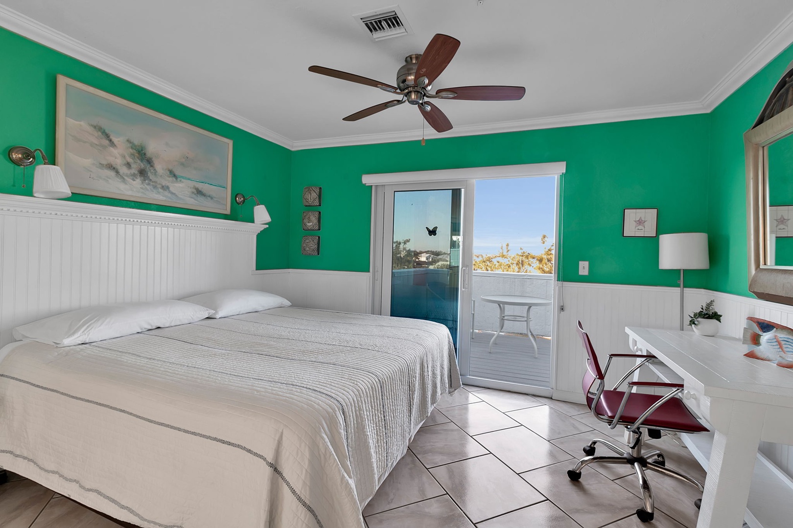 Drift off to sleep in this vibrant bedroom where crisp coastal colors meet modern comfort. Step through sliding doors to your private balcony overlooking warm skies and palms.