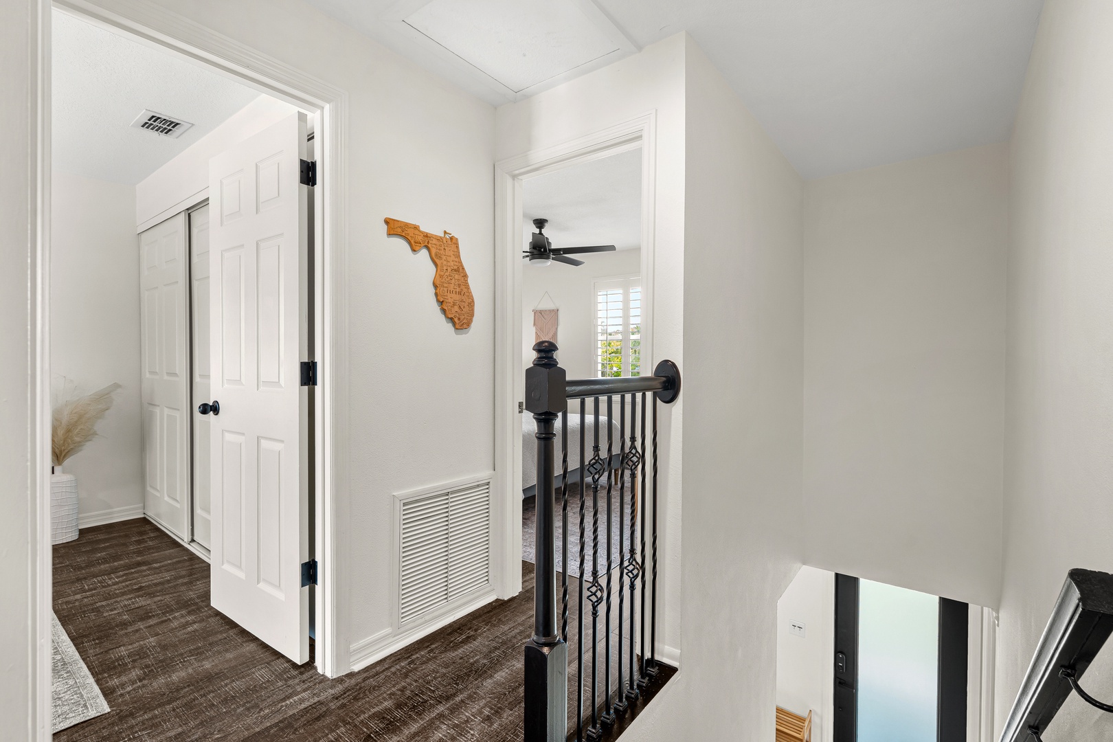 Bright upstairs hallway with Florida charm and modern touches—your serene retreat awaits at the top of the stairs.