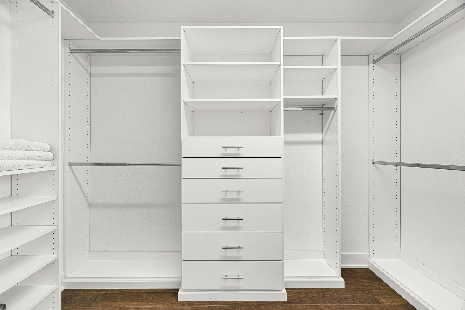 Your spacious walk-in closet offers custom shelving, multiple hanging rods, and six built-in drawers, giving you plenty of room to unpack and feel truly at home during your stay.