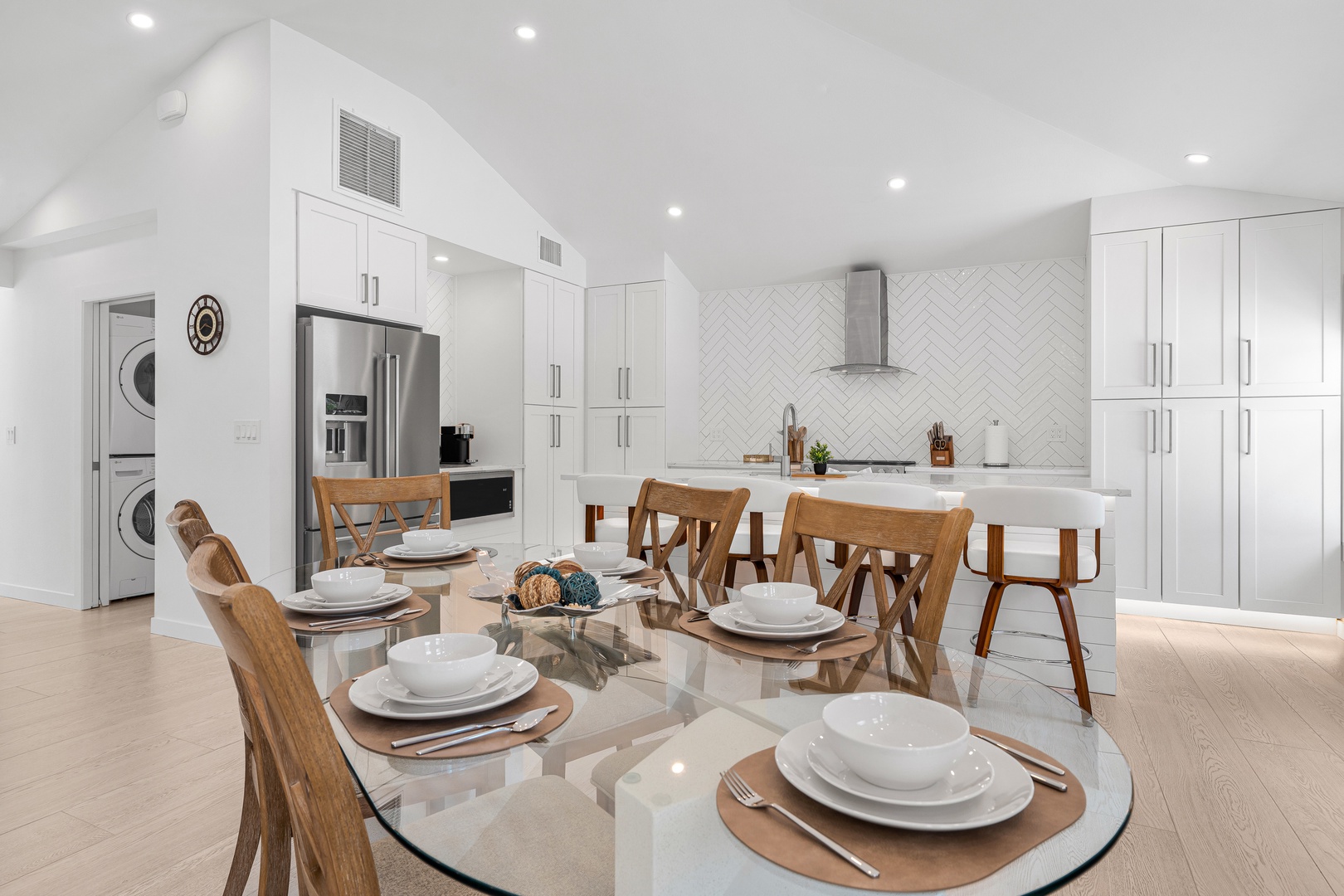 Gather around this bright, open dining and kitchen space where your group can cook, share meals, and create memories together in a stylish, modern setting.