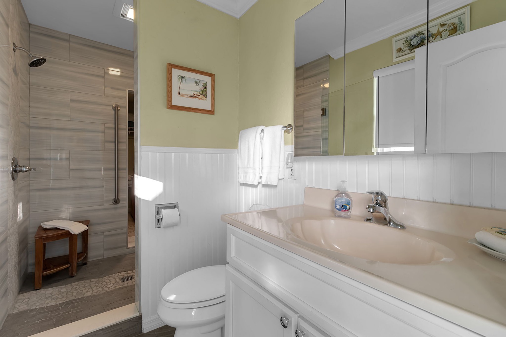 Step into your bright, spotless bathroom with a walk-in shower, fresh towels, and coastal charm—everything you need to unwind after a day of adventure.