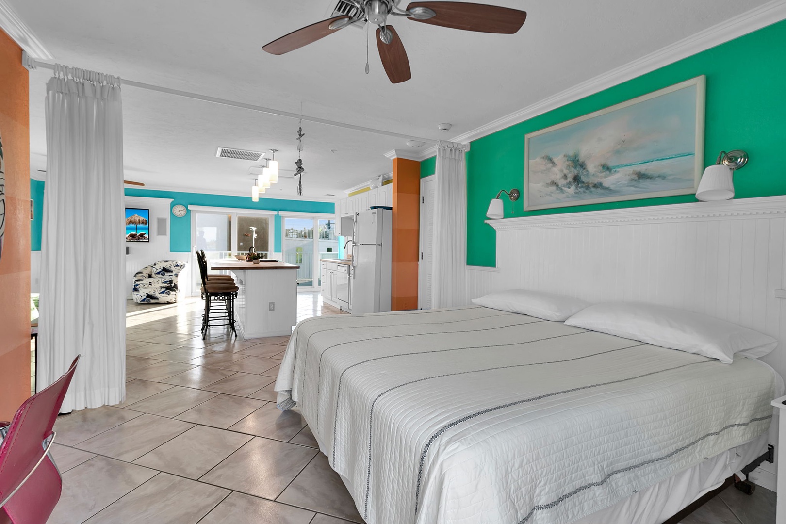 Bright, open-concept retreat with vibrant tropical colors. Spacious bedroom, airy living area, and welcoming kitchen—your perfect island home base for unforgettable adventures.