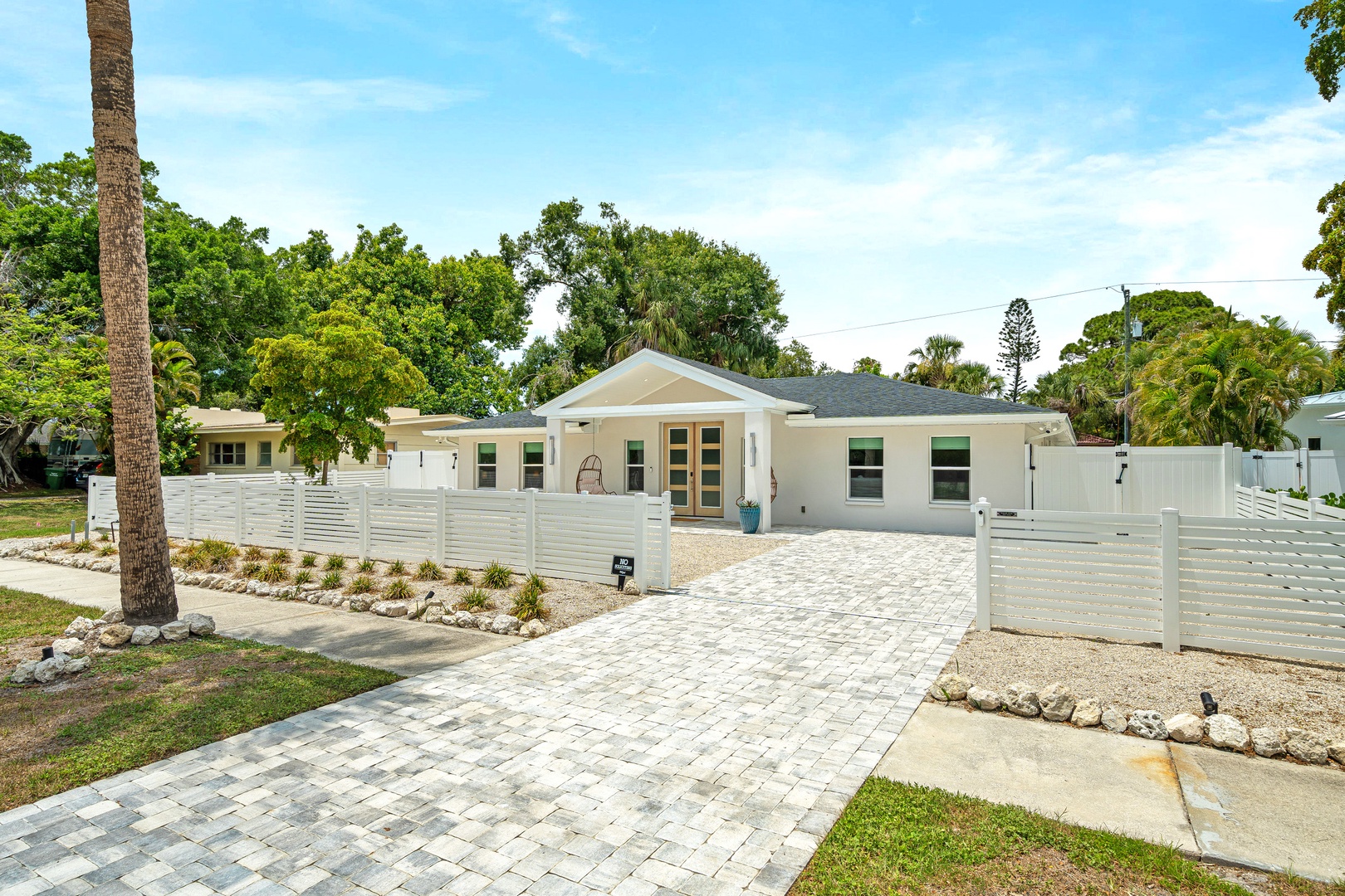 Charming coastal-style home nestled in a peaceful neighborhood with a spacious driveway.