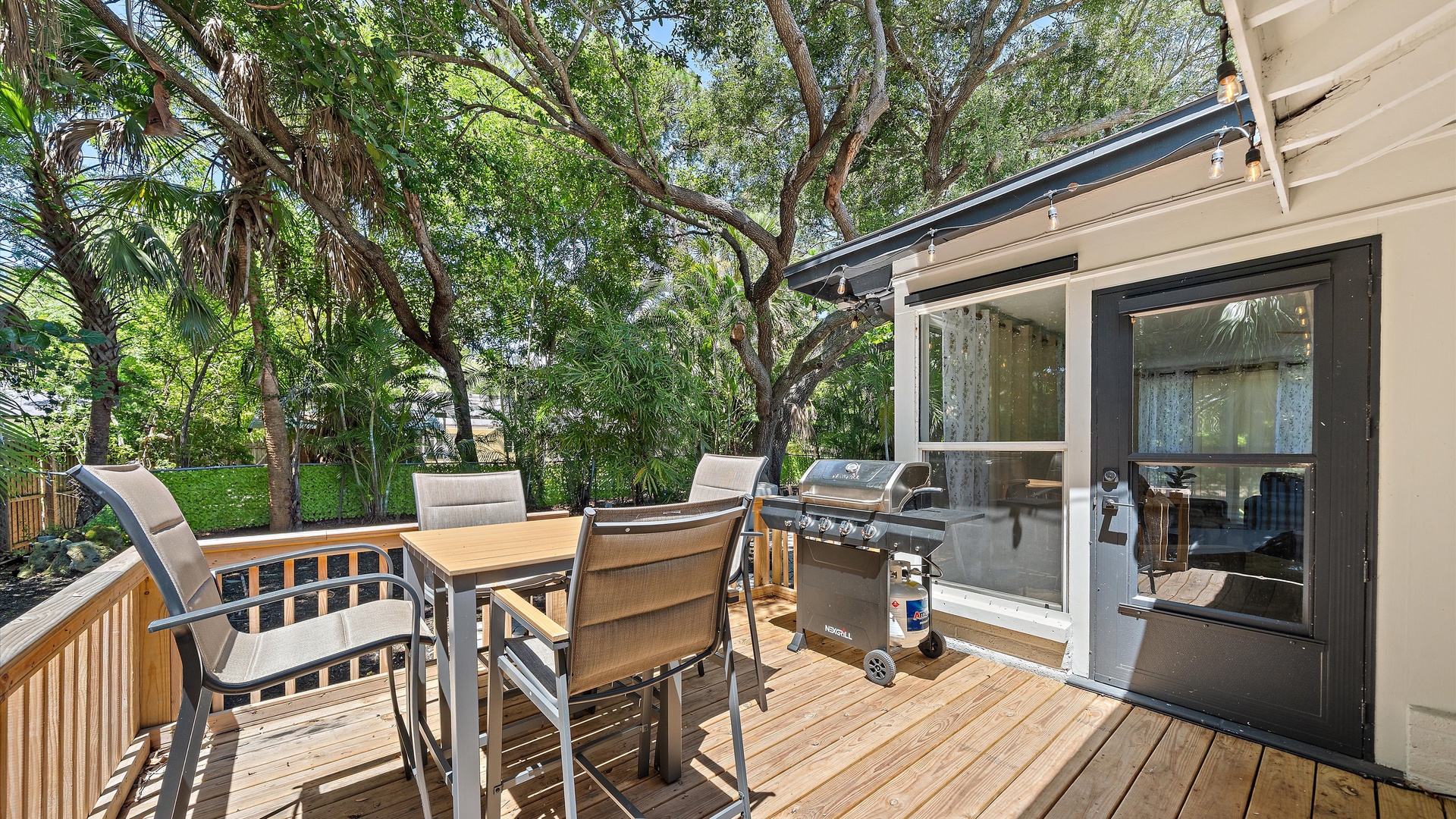 Your private deck opens to a lush garden setting, where you can fire up the built-in grill and gather around the outdoor dining table. Surrounded by mature trees, it's the perfect spot to unwind and enjoy meals in the fresh air.