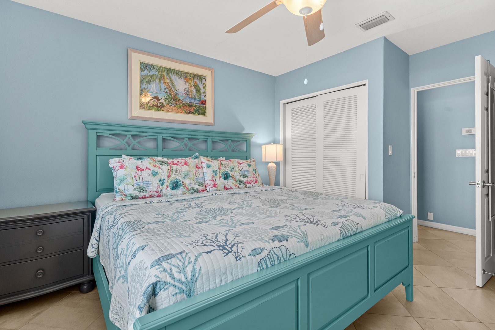 Drift off in your coastal-themed bedroom with beach views under a gentle ceiling fan.