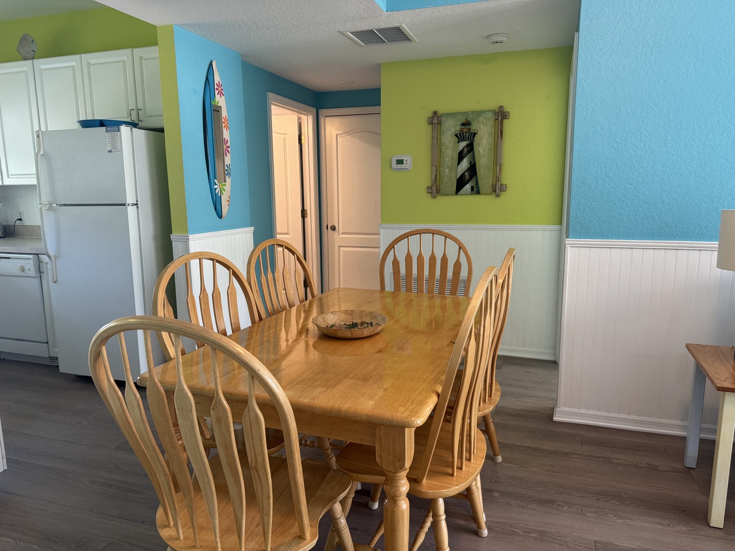 Gather around the dining table for meals and laughter in this bright, beachy space where coastal vibes meet home comfort.