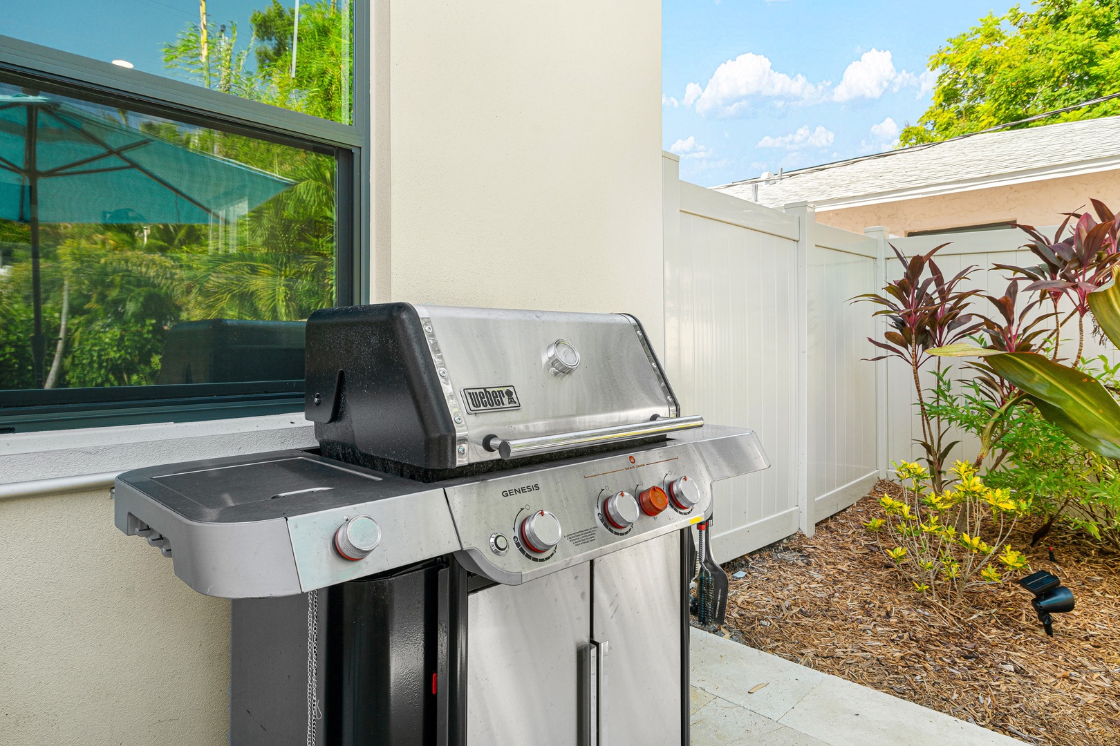 Fire up the grill and enjoy cooking outdoors in your private backyard space, complete with tropical landscaping and sunny Florida weather.