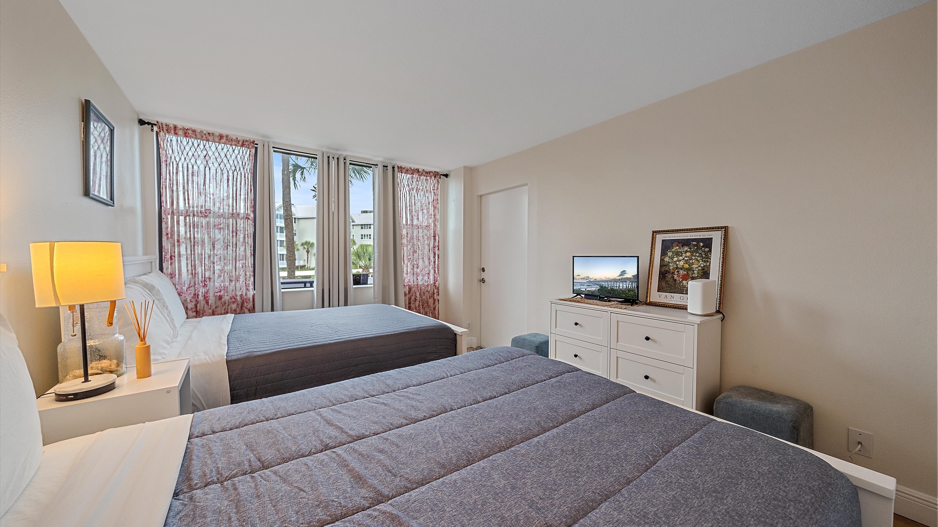 Relax in your comfortable bedroom with two cozy beds, modern furnishings, and a flat-screen TV for your entertainment.