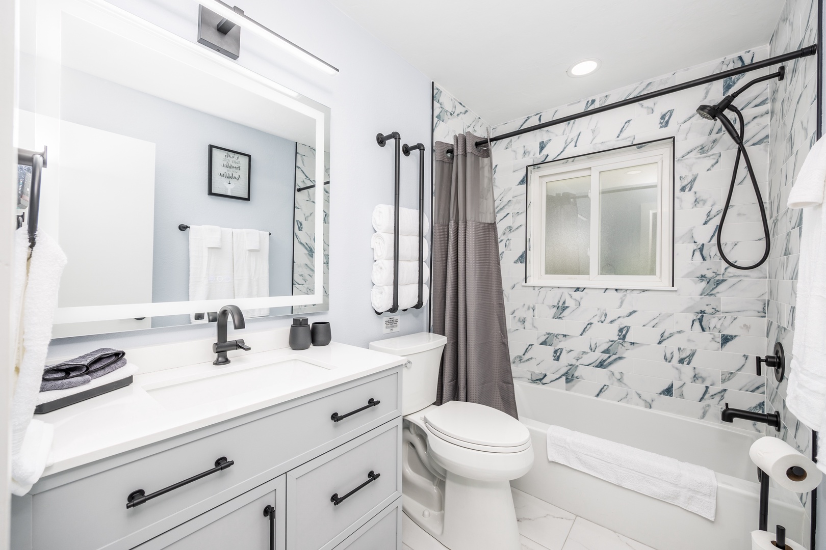 Pamper yourself in this stunning marble bathroom with luxurious soaking tub, elegant vanity, and sophisticated black fixtures creating your perfect spa retreat.