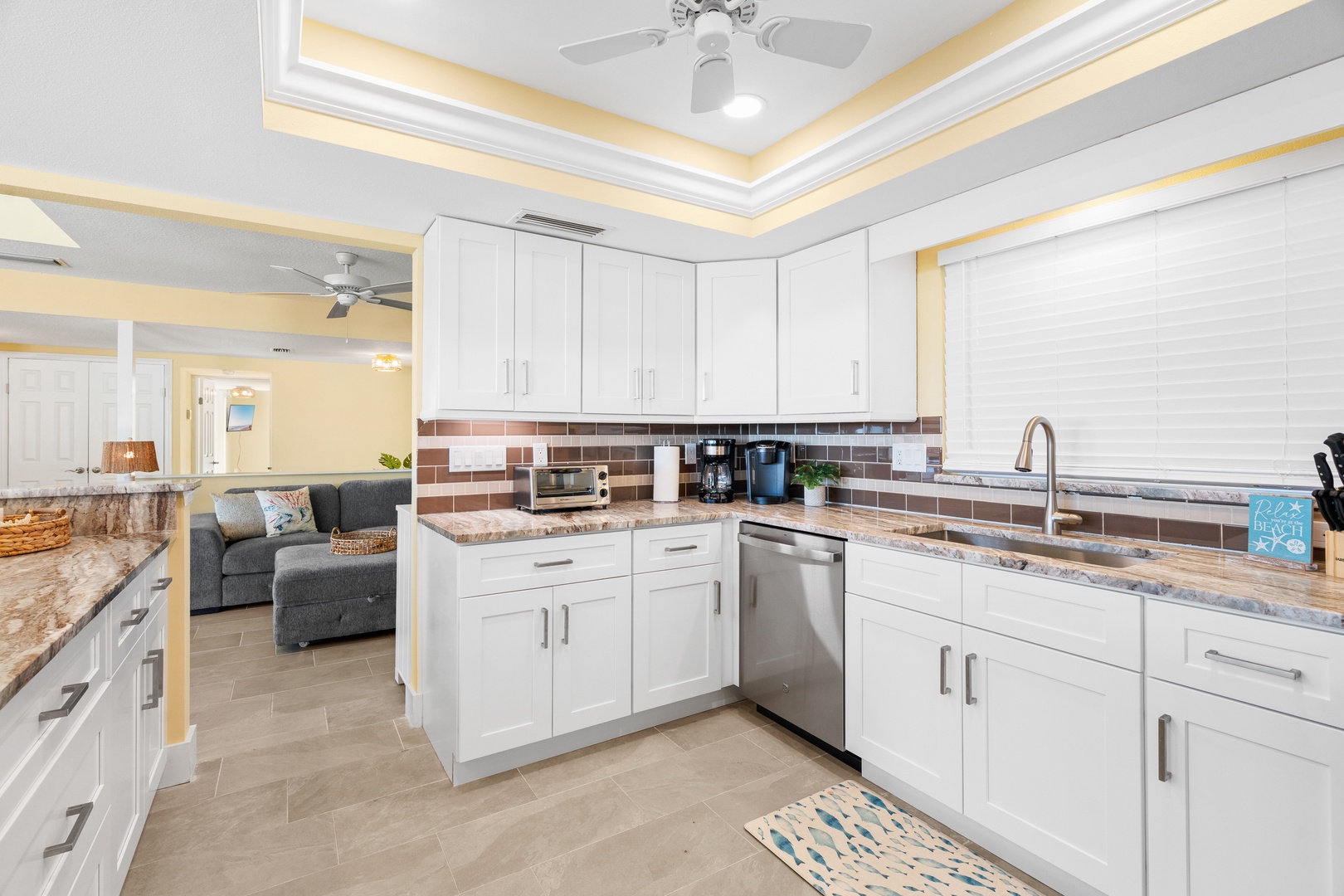 Your gourmet kitchen features granite countertops, modern appliances, and elegant white cabinetry, perfect for creating memorable meals during your stay.