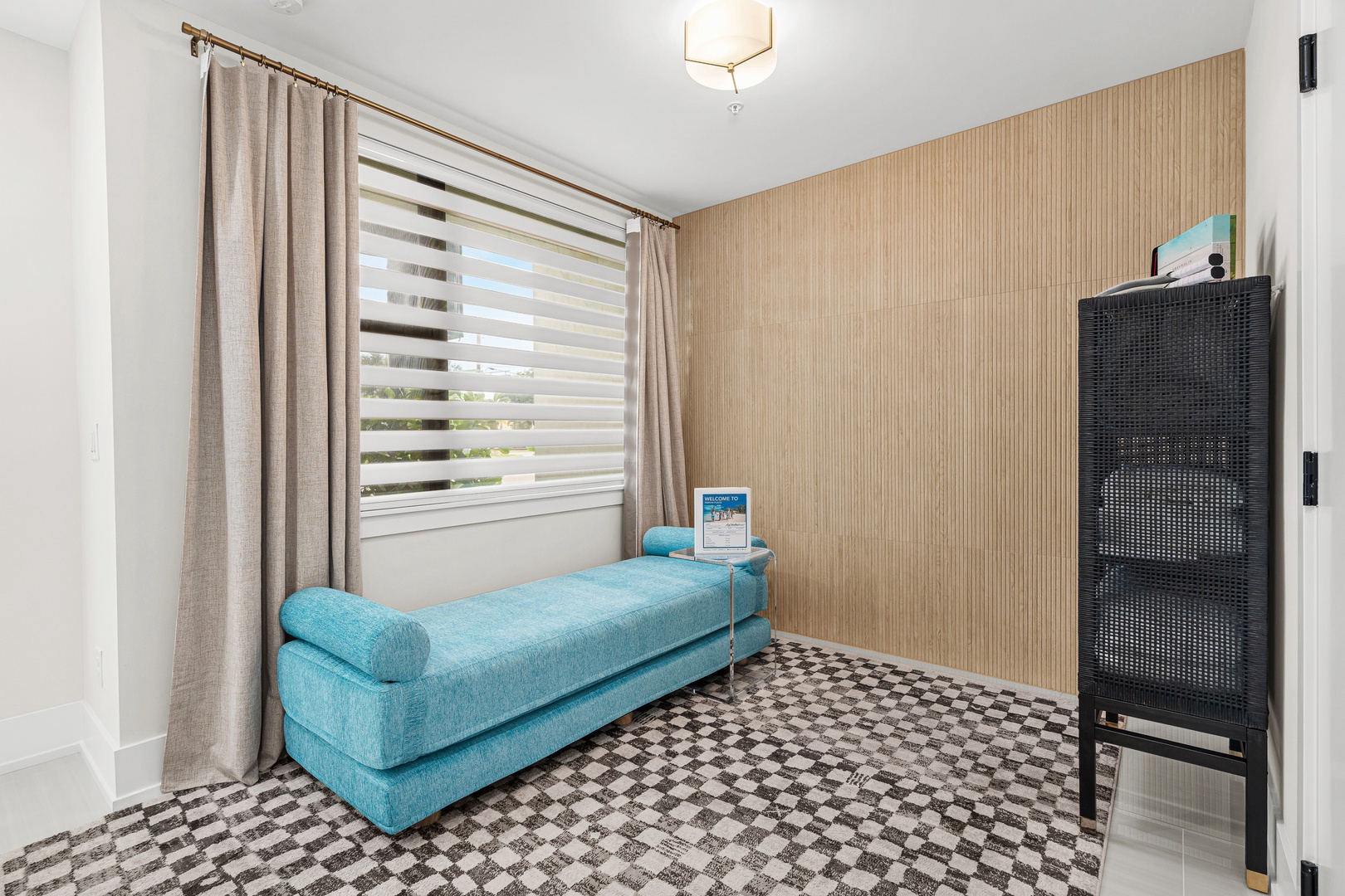 Settle into your tranquil retreat with a plush turquoise daybed and soft natural light filtering through custom window treatments. The textured accent wall and distinctive tile create a calm, inviting atmosphere perfect for unwinding.