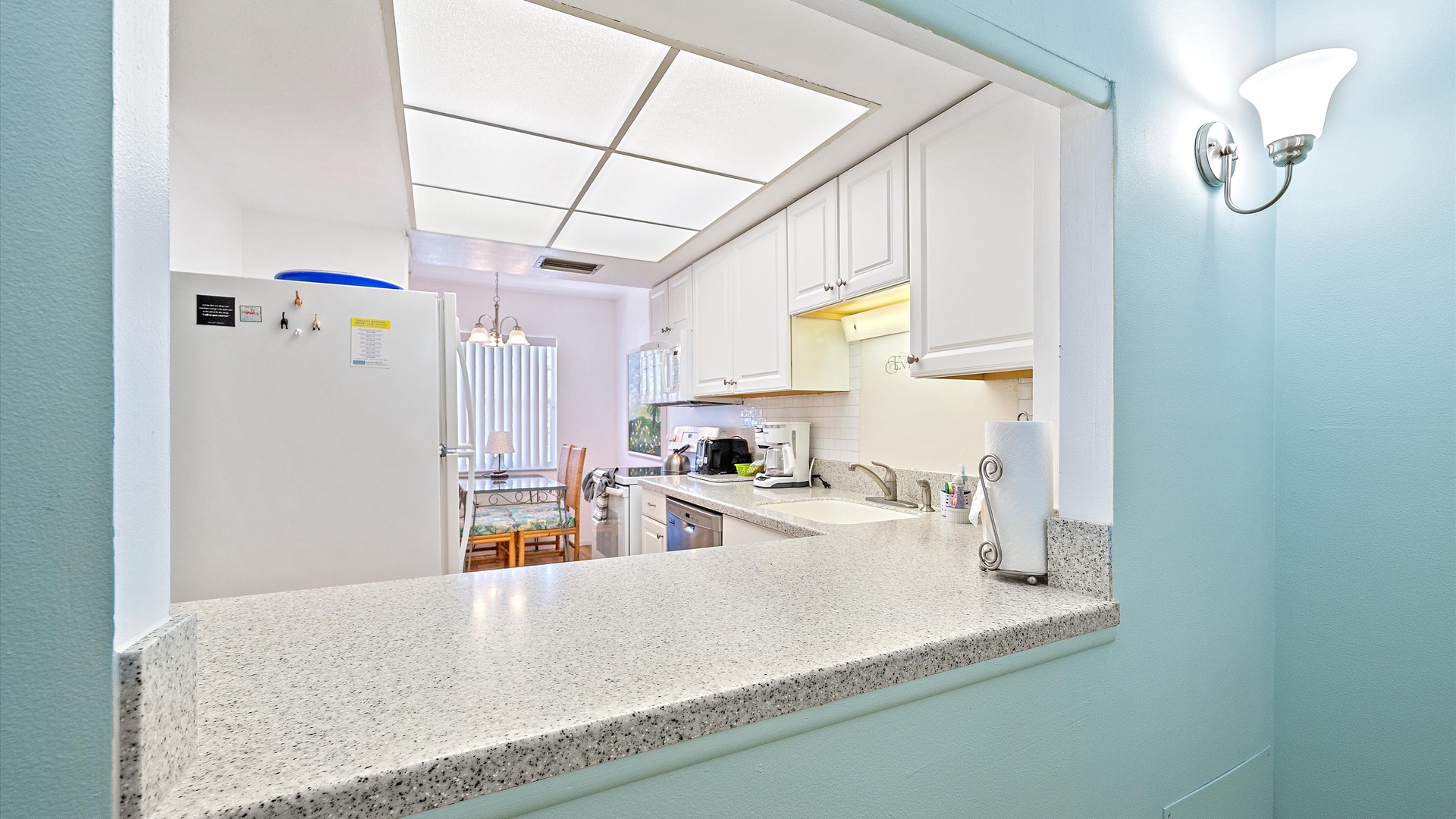 Your bright, fully-equipped kitchen welcomes you with white cabinetry, granite counters, and modern appliances. Enjoy meal prep in this cheerful space, where the open layout connects effortlessly to your dining area.