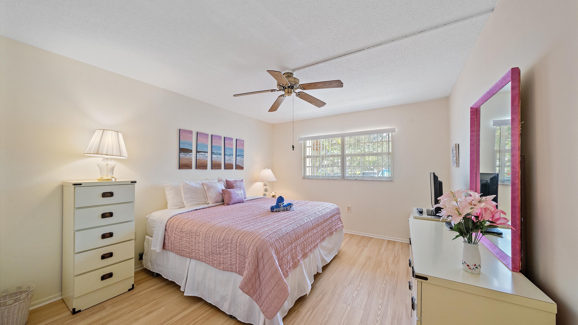Sink into soft linens and wake refreshed in your bright, airy bedroom. Natural light fills the space, while ceiling fan and tasteful decor create a cozy retreat.