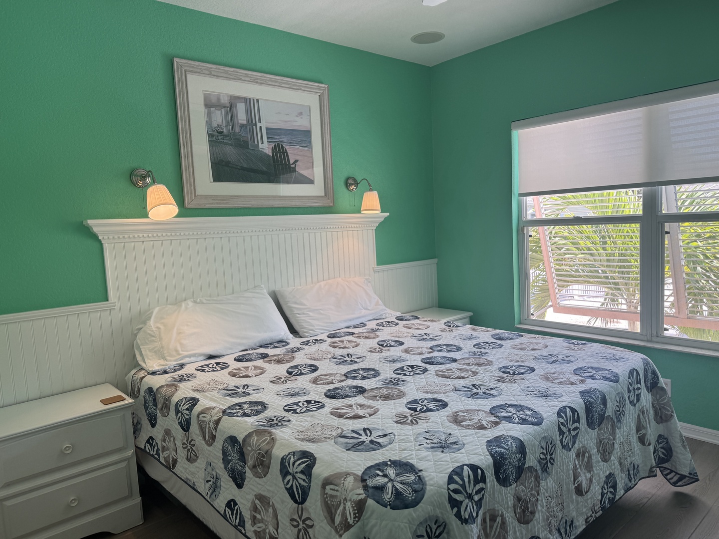 Step into your coastal retreat with soothing turquoise walls and soft natural light. Palm trees peek through your window, bringing the tropics right to your bedside.