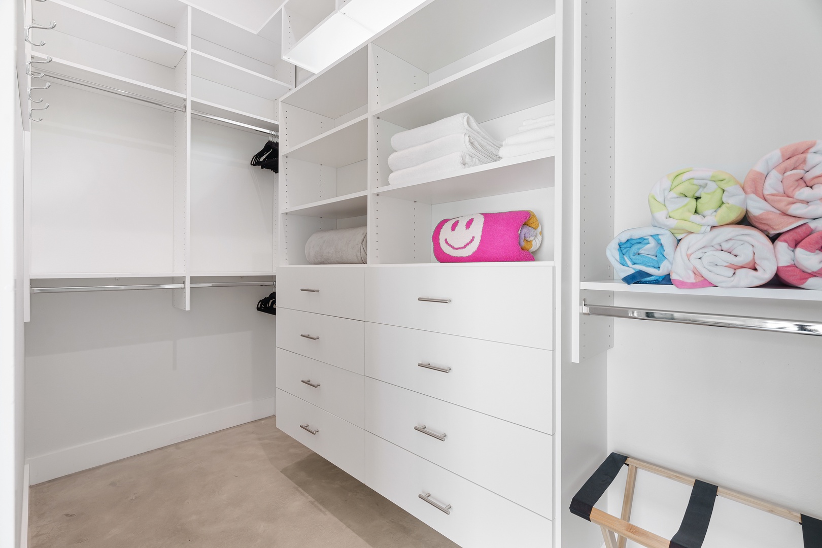 Your spacious walk-in closet features plenty of hanging space, built-in drawers, and organized shelving to keep your belongings neatly arranged throughout your stay.