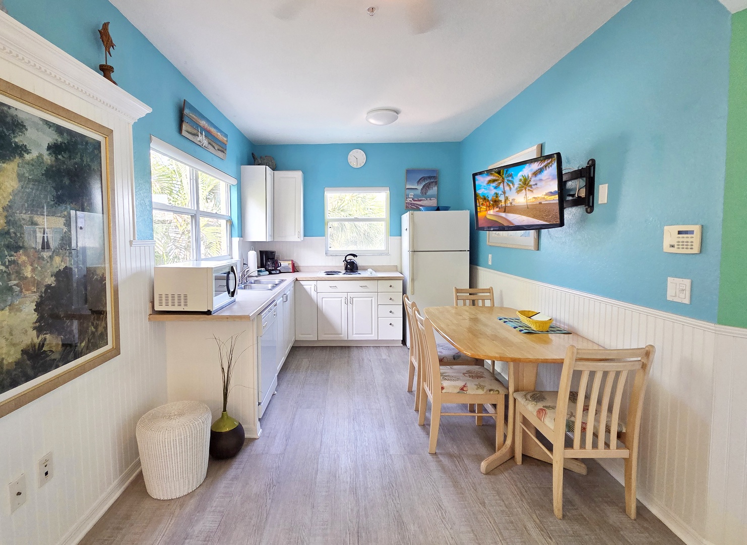 Enjoy your own fully-equipped kitchen with charming coastal colors, white cabinetry, and everything you need to prepare your favorite meals. The dining table invites you to gather and savor home-cooked moments together.