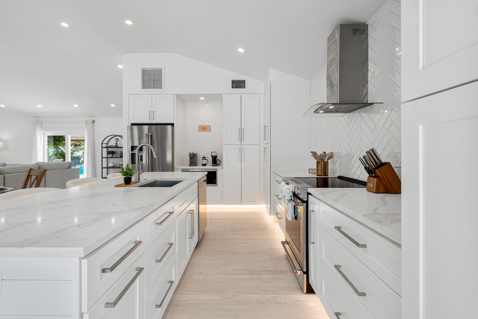 Gather and create in this bright, spacious kitchen with marble countertops, stainless steel appliances, and sleek white cabinetry—your culinary haven awaits.