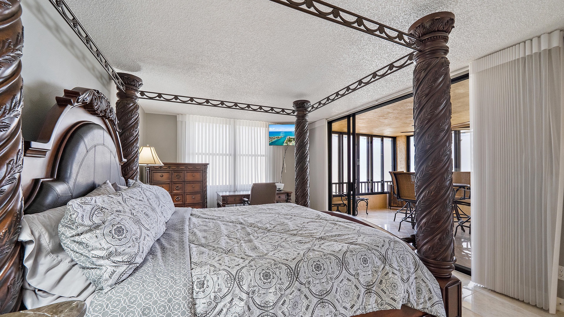 Retreat to your grand four-poster bed with ornate carvings, where elegant linens invite peaceful sleep in this sophisticated bedroom.