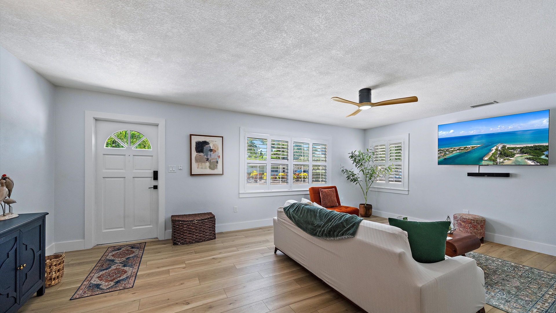 Relax in your bright, spacious living room with stylish decor and comfortable seating. Large plantation shutters let in natural light, while the modern ceiling fan keeps you cool.