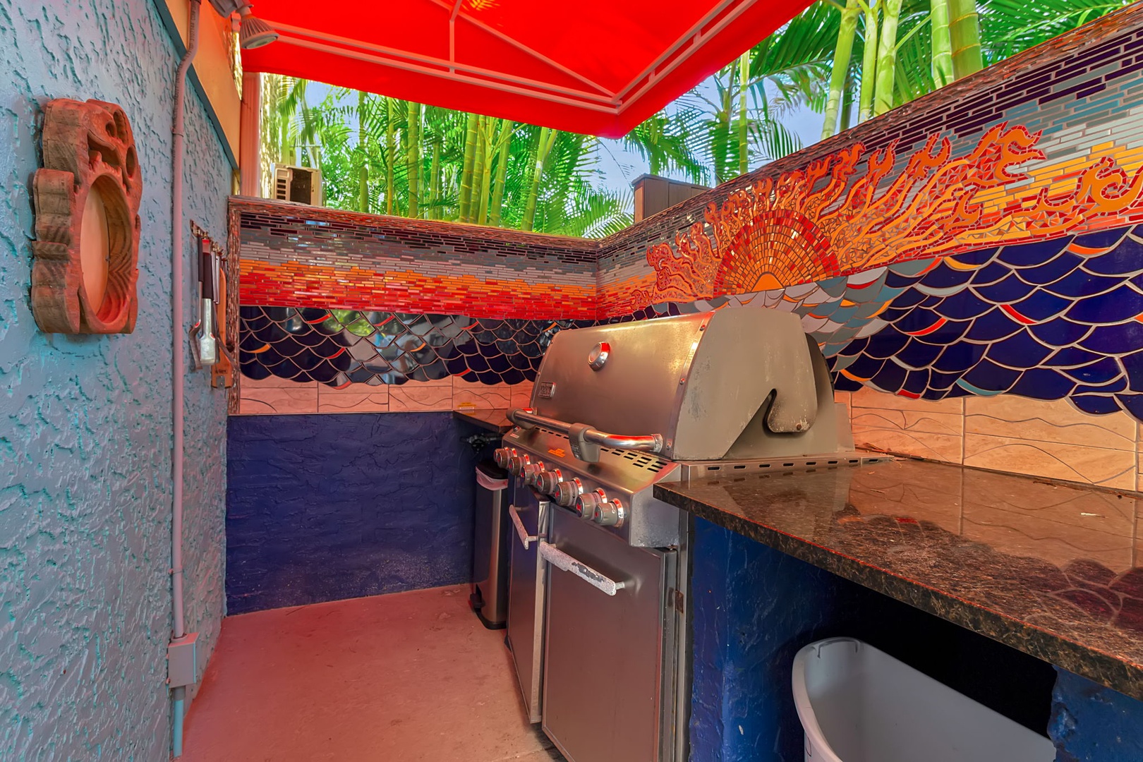 Fire up the grill in your private tropical BBQ courtyard, shaded by vibrant palms and bold mosaic tile work—perfect for lazy afternoons grilling and unwinding in colorful surroundings.