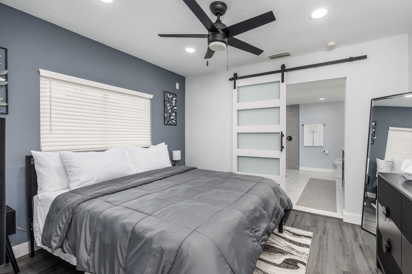 Unwind in your stylish bedroom featuring crisp linens, modern design, and an ensuite bathroom just steps away.