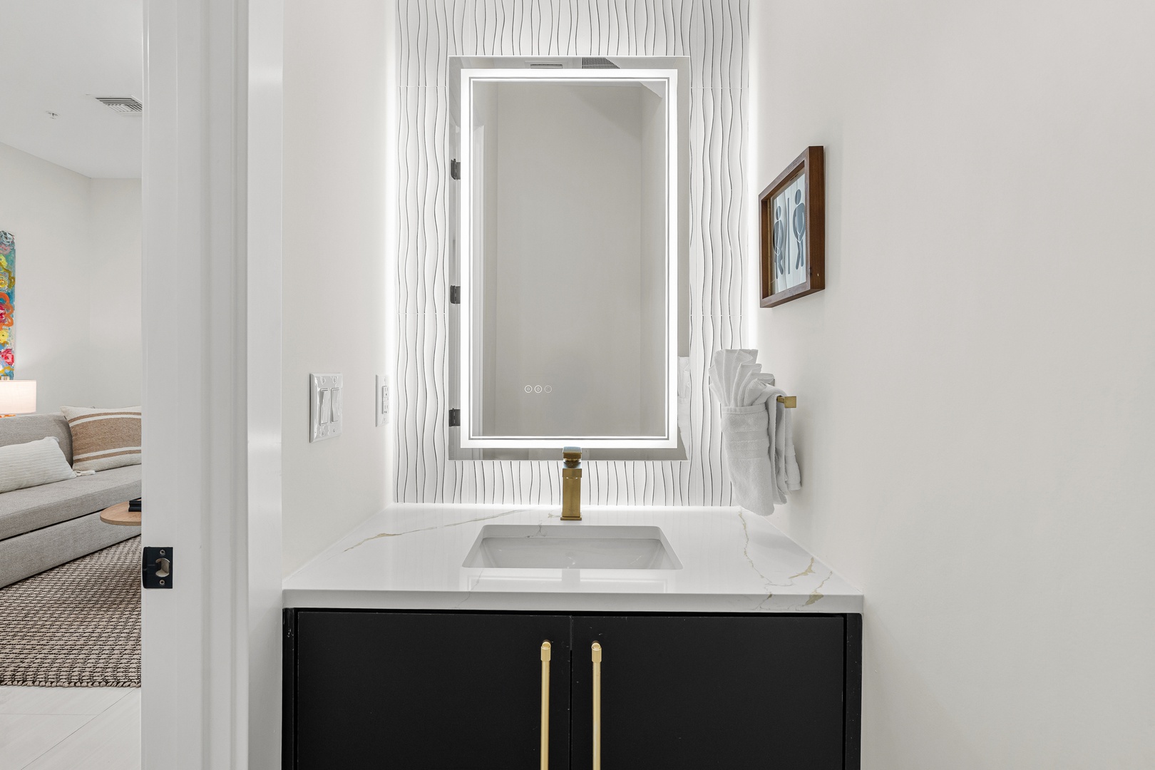 Freshen up in your beautifully appointed bathroom with modern finishes, an illuminated mirror, and elegant fixtures that make getting ready a pleasure.
