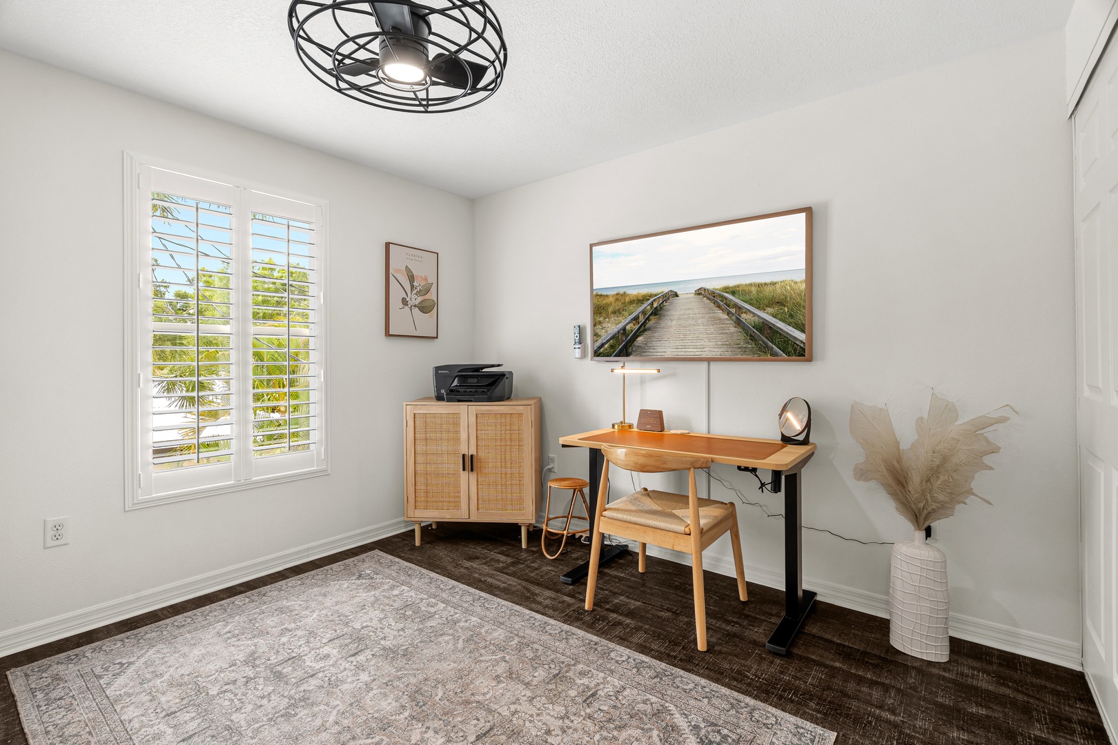 Your tranquil workspace awaits, complete with natural light from shuttered windows, inspiring artwork, and a dedicated desk—perfect for balancing work and relaxation during your stay.