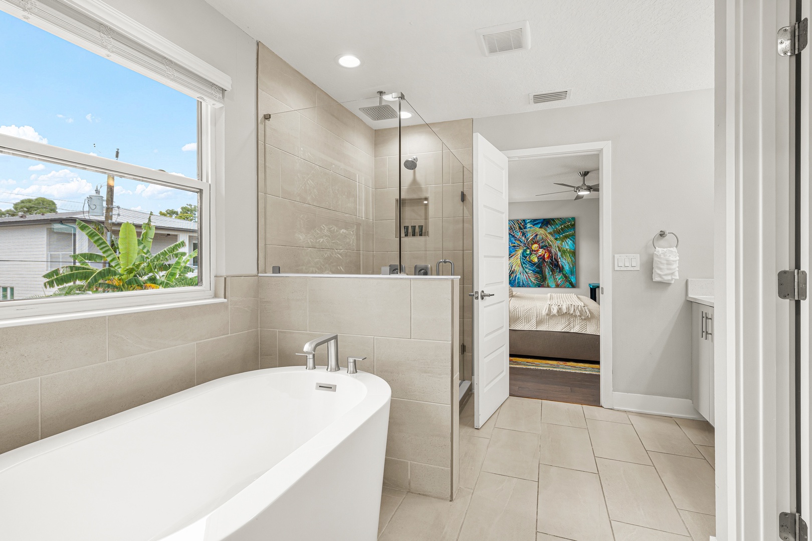 Step into your spa-like ensuite with a luxurious soaking tub, sleek walk-in shower, and soft natural light streaming through the window—your private oasis for unwinding.