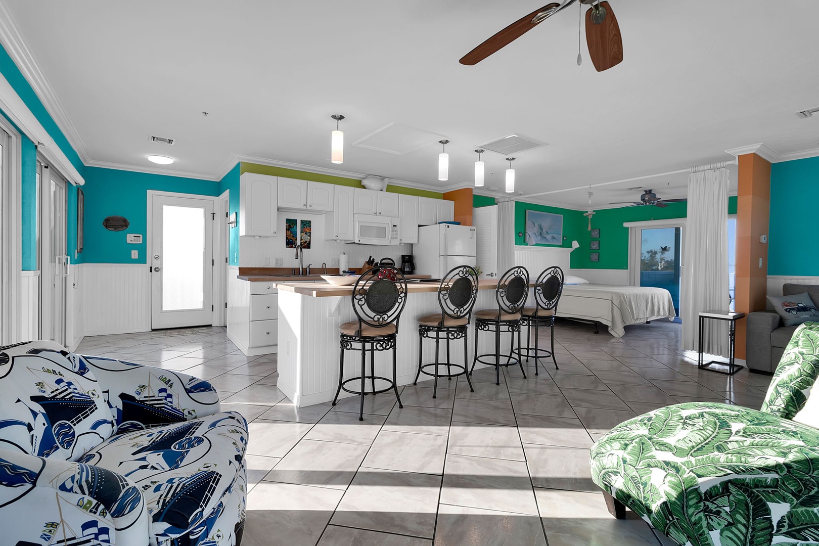 Step into your vibrant coastal retreat, where colorful walls and tropical touches blend seamlessly with an open layout that flows from your kitchen to your living space and beyond.
