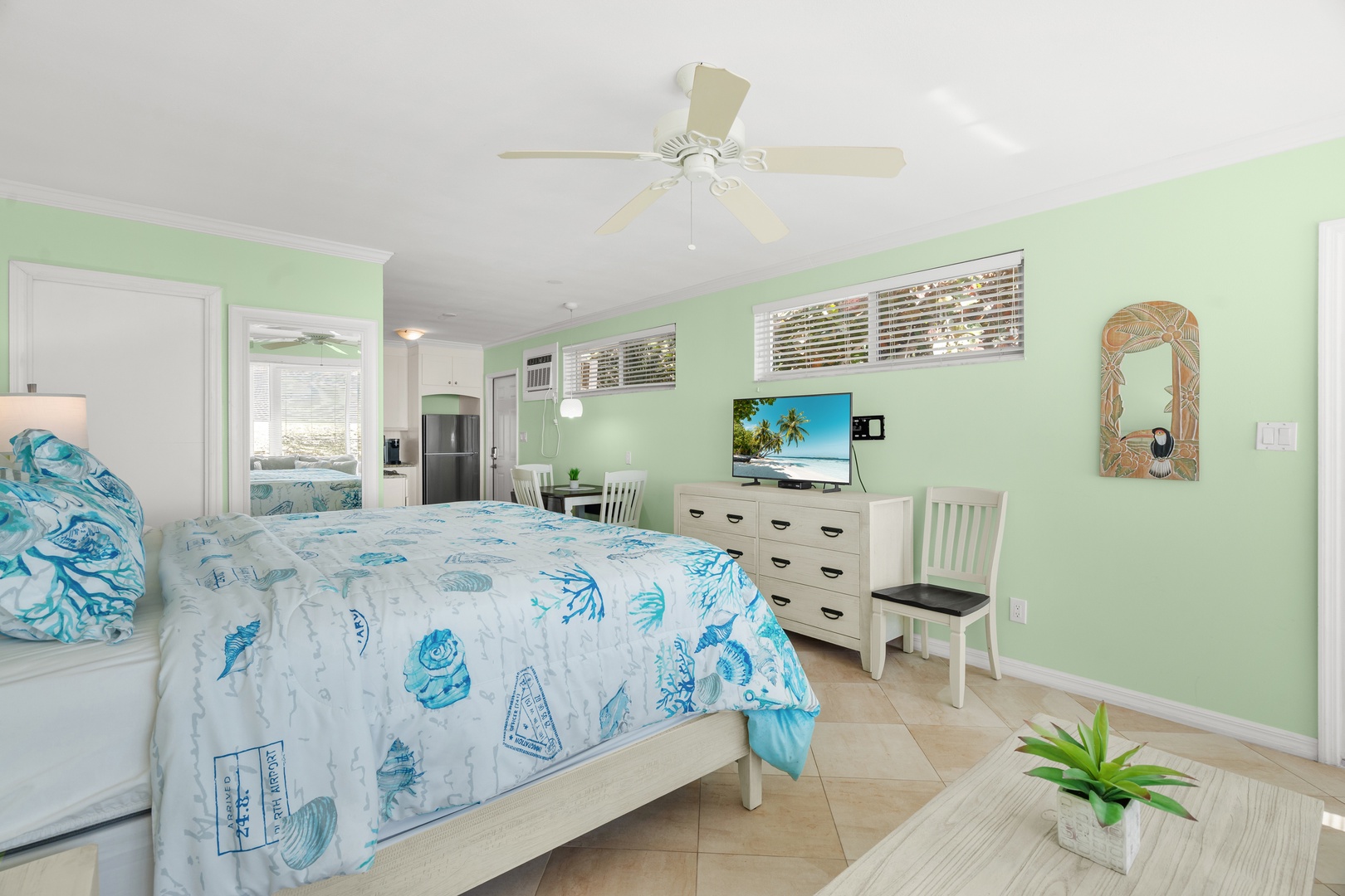 Drift into coastal dreams in your ocean-themed bedroom, where turquoise linens and mint walls create a serene seaside sanctuary.